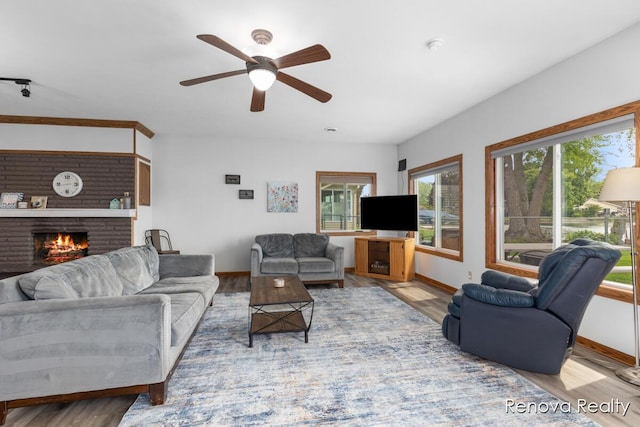 4278 W Joy Rd, Shelbyville, MI 49344 - living room with a fireplace, a ceiling fan, and wood finished floors