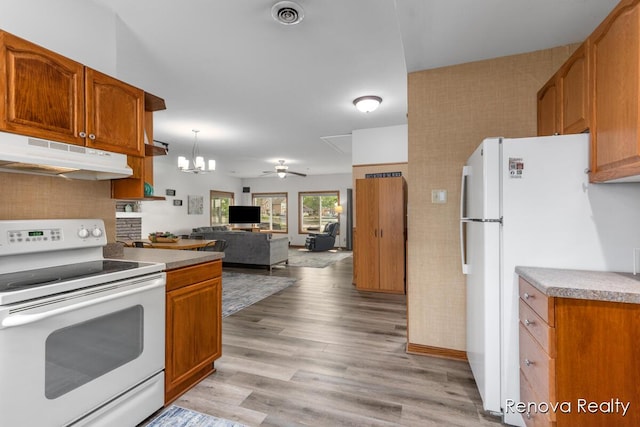 4278 W Joy Rd, Shelbyville, MI 49344 - kitchen featuring white appliances, under cabinet range hood, brown cabinets, and light wood-style floors