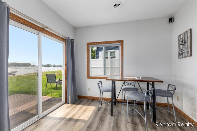 4278 W Joy Rd, Shelbyville, MI 49344 - dining space with wood finished floors and a water view
