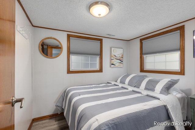 4278 W Joy Rd, Shelbyville, MI 49344 - bedroom featuring ornamental molding, wood finished floors, and a textured ceiling
