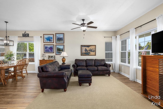 195 Liberty St NW, Sparta, MI 49345 - living room with healthy amount of natural light, wood finished floors, ceiling fan, and a chandelier