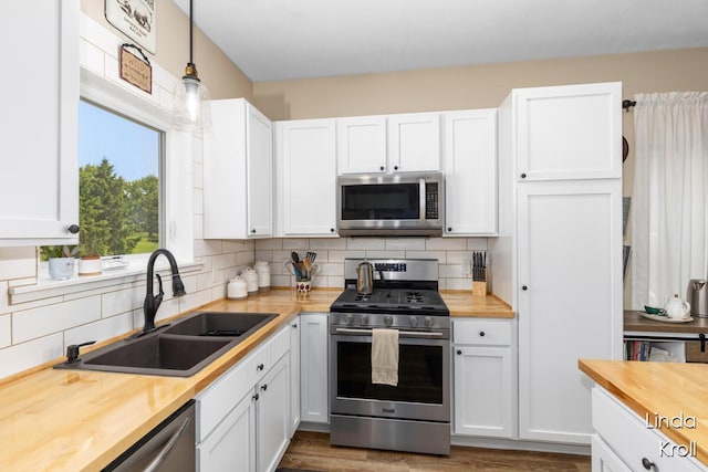 195 Liberty St NW, Sparta, MI 49345 - kitchen with wooden counters, appliances with stainless steel finishes, and tasteful backsplash