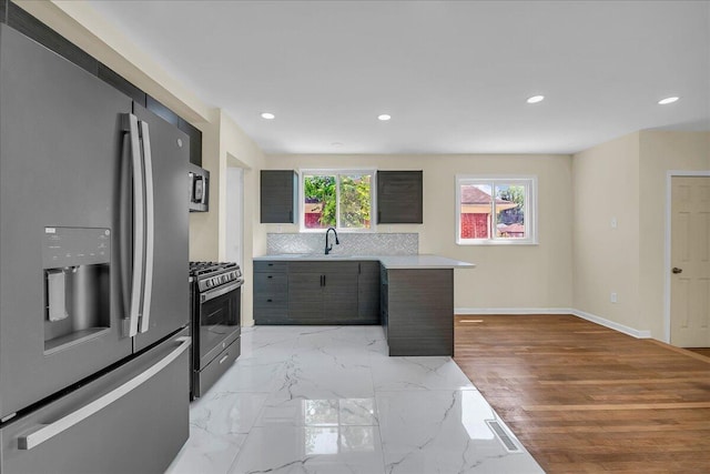 20232 Braile St, Detroit, MI 48219 - kitchen featuring stainless steel appliances, a peninsula, light countertops, recessed lighting, and backsplash