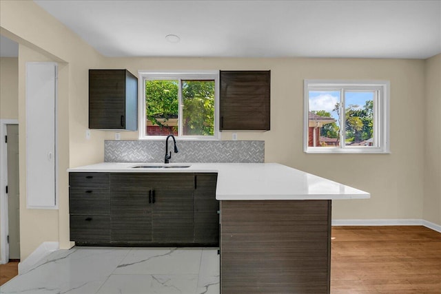 20232 Braile St, Detroit, MI 48219 - kitchen with light countertops, tasteful backsplash, modern cabinets, and dark brown cabinetry