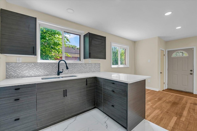 20232 Braile St, Detroit, MI 48219 - kitchen with gray cabinets, light countertops, a peninsula, modern cabinets, and backsplash