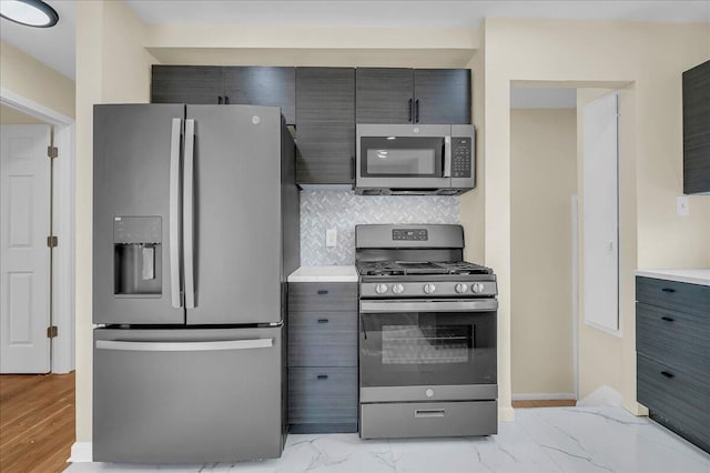 20232 Braile St, Detroit, MI 48219 - kitchen with stainless steel appliances, light countertops, decorative backsplash, and light marble finish flooring