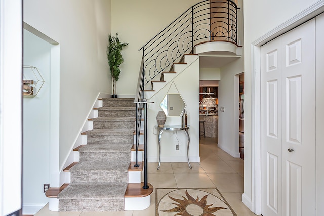 3185 Shadberry Ct, Saline, MI 48176 - stairs featuring tile patterned flooring, a high ceiling, and arched walkways