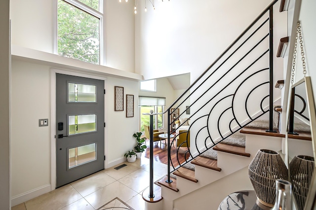 3185 Shadberry Ct, Saline, MI 48176 - foyer entrance with a towering ceiling, stairs, and light tile patterned floors