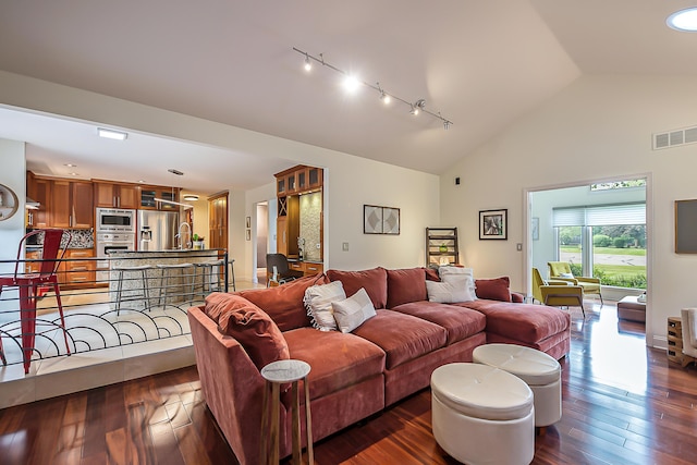 3185 Shadberry Ct, Saline, MI 48176 - living room with dark wood finished floors, high vaulted ceiling, and track lighting