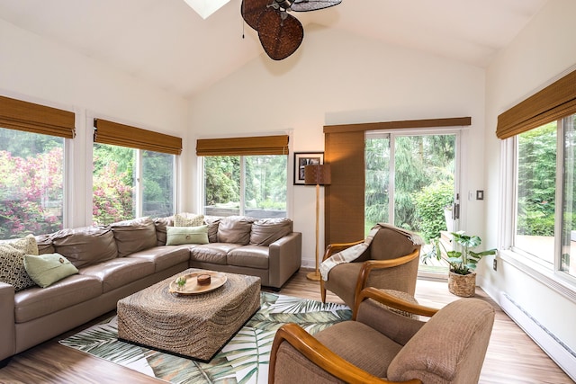 3185 Shadberry Ct, Saline, MI 48176 - living room featuring a baseboard heating unit, ceiling fan, light wood-style flooring, and high vaulted ceiling