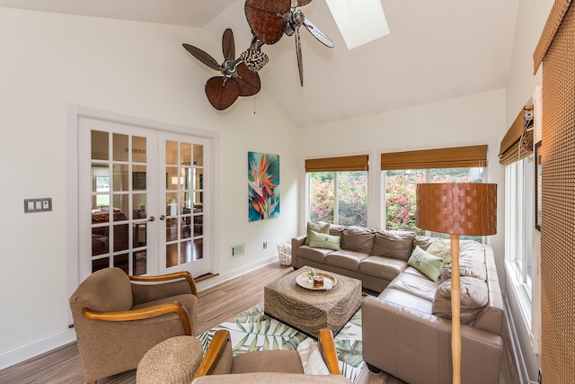 3185 Shadberry Ct, Saline, MI 48176 - living area with ceiling fan, wood finished floors, french doors, high vaulted ceiling, and a skylight