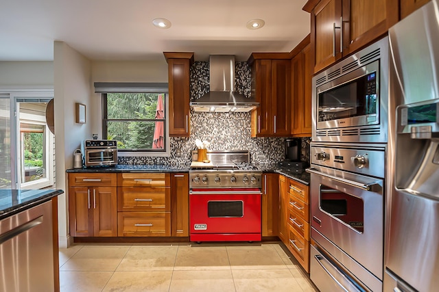 3185 Shadberry Ct, Saline, MI 48176 - kitchen featuring stainless steel appliances, wall chimney range hood, backsplash, dark stone countertops, and recessed lighting