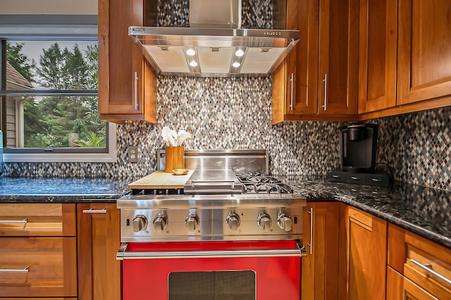 3185 Shadberry Ct, Saline, MI 48176 - kitchen with high end stainless steel range oven, under cabinet range hood, brown cabinets, backsplash, and dark stone counters