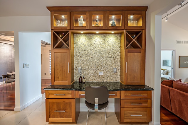 3185 Shadberry Ct, Saline, MI 48176 - office space with built in study area, light tile patterned floors, and track lighting