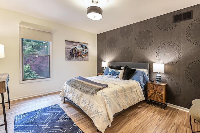 3185 Shadberry Ct, Saline, MI 48176 - bedroom featuring wood finished floors and an accent wall