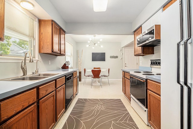 1775 Franklin Ct S, Ann Arbor, MI 48103 - kitchen with white appliances, a chandelier, brown cabinetry, and light countertops