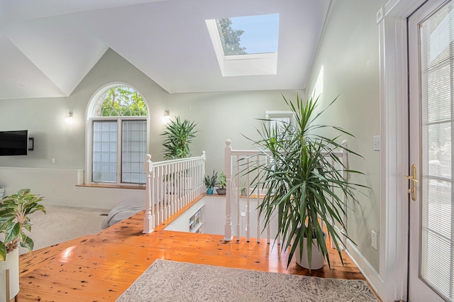 1775 Franklin Ct S, Ann Arbor, MI 48103 - staircase with a skylight, wood finished floors, and vaulted ceiling