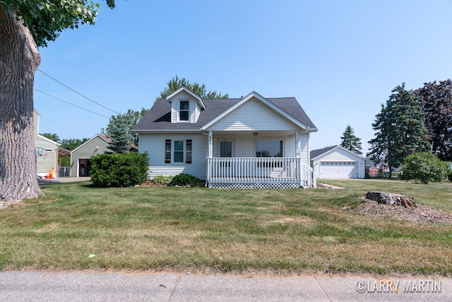 641 52nd St SE, Grand Rapids, MI 49548 - view of front of home with a porch, a detached garage, a front lawn, and a shingled roof