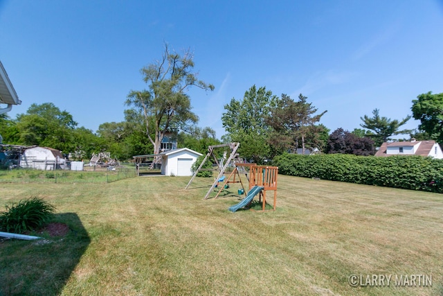 641 52nd St SE, Grand Rapids, MI 49548 - view of yard featuring a playground, a garage, and a storage shed