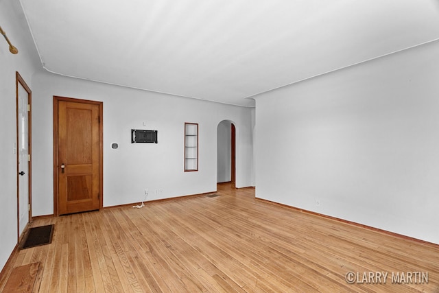 641 52nd St SE, Grand Rapids, MI 49548 - spare room featuring arched walkways and light wood-style floors
