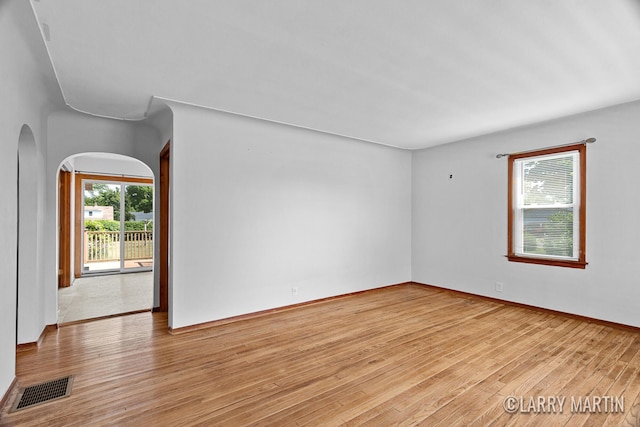641 52nd St SE, Grand Rapids, MI 49548 - empty room with arched walkways and light wood finished floors