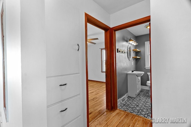 641 52nd St SE, Grand Rapids, MI 49548 - corridor featuring wood finished floors and baseboards