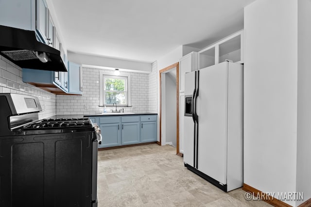 641 52nd St SE, Grand Rapids, MI 49548 - kitchen featuring range with gas stovetop, white fridge with ice dispenser, under cabinet range hood, tasteful backsplash, and blue cabinets