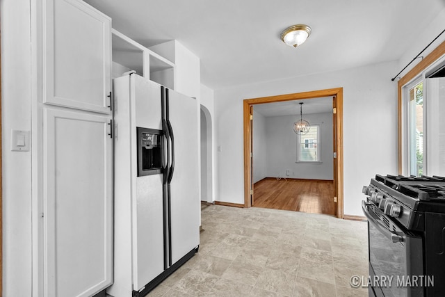 641 52nd St SE, Grand Rapids, MI 49548 - kitchen featuring white fridge with ice dispenser, gas stove, healthy amount of natural light, and open shelves
