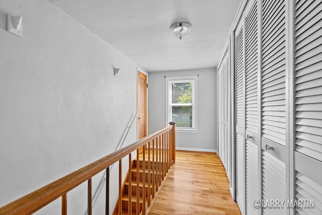 641 52nd St SE, Grand Rapids, MI 49548 - hall with light wood-style floors and an upstairs landing