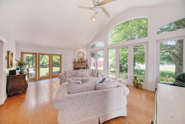 6990 Kennedy Rd, Munith, MI 49259 - living area with healthy amount of natural light, light wood-style floors, ceiling fan, and high vaulted ceiling