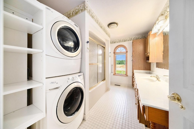 6990 Kennedy Rd, Munith, MI 49259 - washroom with stacked washer and clothes dryer and light tile patterned floors