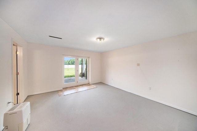 6990 Kennedy Rd, Munith, MI 49259 - empty room featuring concrete flooring and baseboards