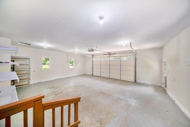 6990 Kennedy Rd, Munith, MI 49259 - garage featuring baseboards and a garage door opener
