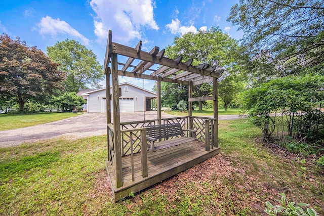 6990 Kennedy Rd, Munith, MI 49259 - deck featuring an outbuilding, a lawn, a pergola, and a garage