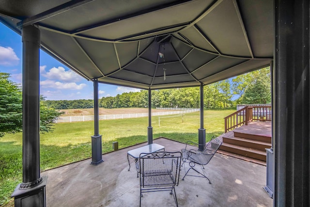 6990 Kennedy Rd, Munith, MI 49259 - view of patio featuring a rural view, view of wooded area, and a wooden deck