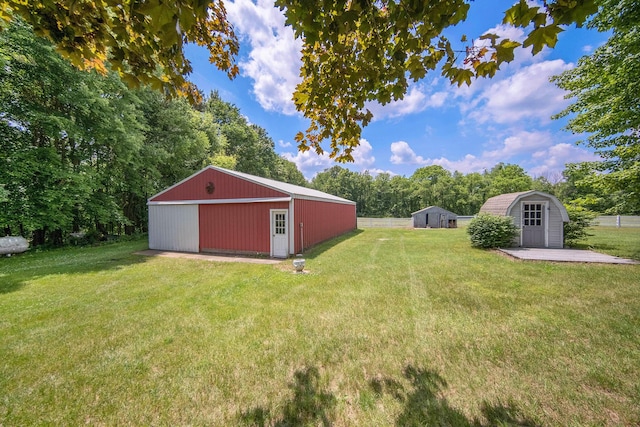 6990 Kennedy Rd, Munith, MI 49259 - view of grassy yard with an outbuilding, a detached garage, and a shed