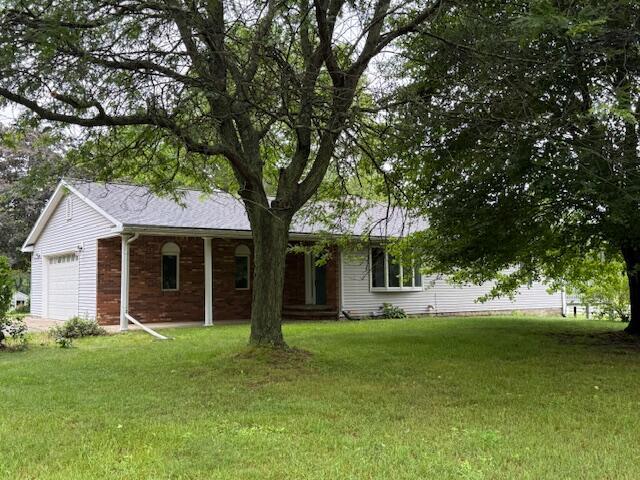 6990 Kennedy Rd, Munith, MI 49259 - ranch-style home with a garage and a front yard