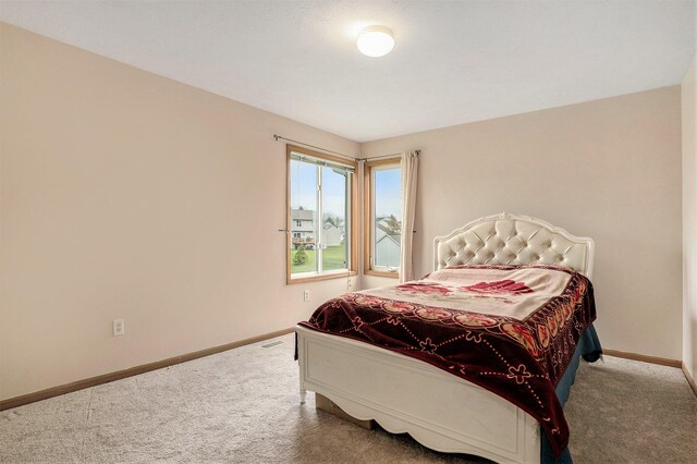 5767 E Grove Dr SE, Kentwood, MI 49512 - carpeted bedroom featuring baseboards