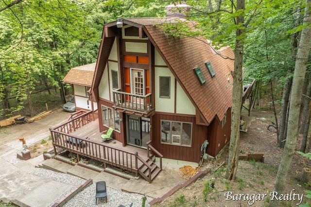9550 Pere Marquette Dr, Stanwood, MI 49346 - back of house featuring roof with shingles, a balcony, a wooden deck, and a patio