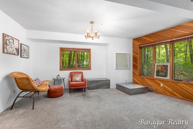 9550 Pere Marquette Dr, Stanwood, MI 49346 - sitting room with wooden walls, a chandelier, and carpet floors