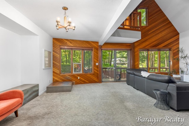 9550 Pere Marquette Dr, Stanwood, MI 49346 - living area with wooden walls, a chandelier, carpet, and high vaulted ceiling