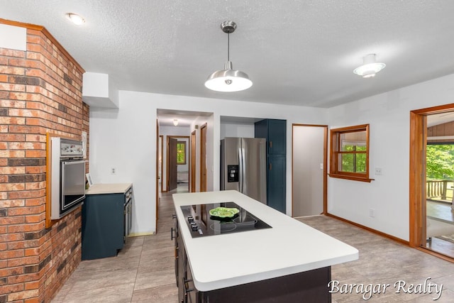 9550 Pere Marquette Dr, Stanwood, MI 49346 - kitchen with stainless steel appliances, light countertops, blue cabinets, a kitchen island, and a textured ceiling