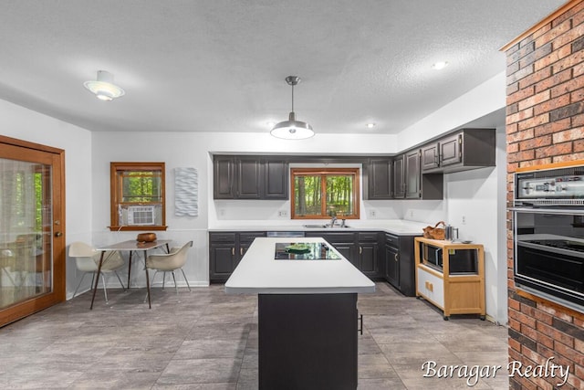 9550 Pere Marquette Dr, Stanwood, MI 49346 - kitchen featuring black appliances, light countertops, a kitchen island, a textured ceiling, and cooling unit