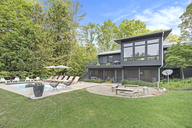 16128 Walnut Ct, Three Oaks, MI 49128 - rear view of house featuring a patio area, stairway, a sunroom, and a lawn