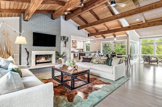 16128 Walnut Ct, Three Oaks, MI 49128 - living area with wooden ceiling, healthy amount of natural light, a ceiling fan, a fireplace, and wood finished floors