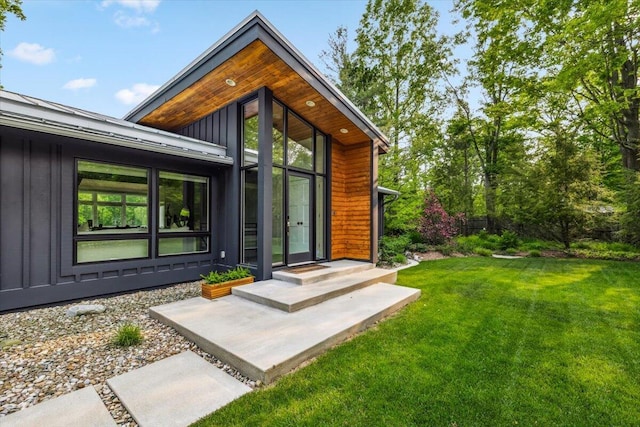 16128 Walnut Ct, Three Oaks, MI 49128 - entrance to property featuring board and batten siding and a yard