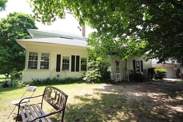 14585 E V Ave, Fulton, MI 49052 - rear view of house with a lawn and a chimney