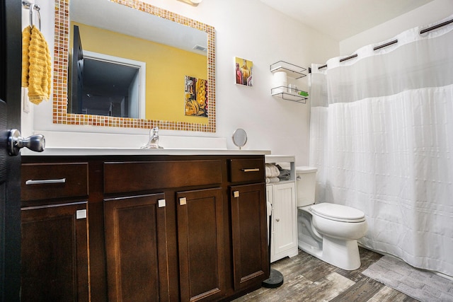 25220 Forest Ln, Mattawan, MI 49071 - bathroom with vanity, wood finished floors, and decorative backsplash