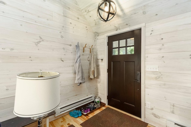 2821 Lakeshore Rd, Lexington, MI 48450 - foyer entrance with a baseboard radiator, wood walls, and wood finished floors