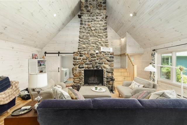 2821 Lakeshore Rd, Lexington, MI 48450 - living room with wood ceiling, a barn door, wood finished floors, high vaulted ceiling, and wood walls